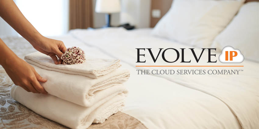 Hotel bed with towels and Evolve IP logo