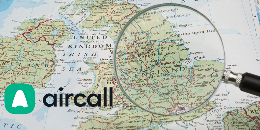 Magnifying glass hovering over UK on map with Aircall logo