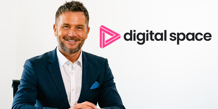 CEO Neil Muller sits at desk with hands folded with Digital Space logo beside him