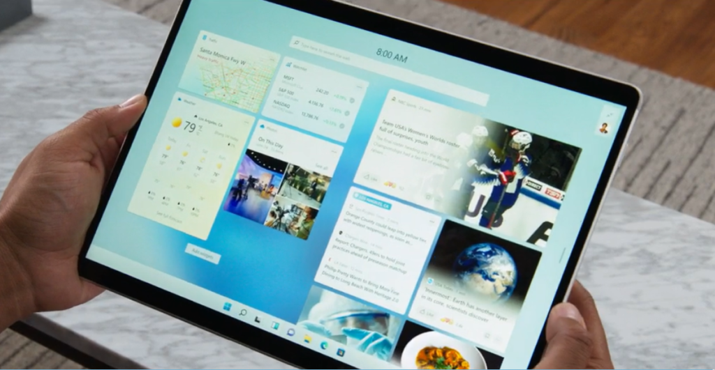 Person holding tablet and using Snap Layouts on Windows 11