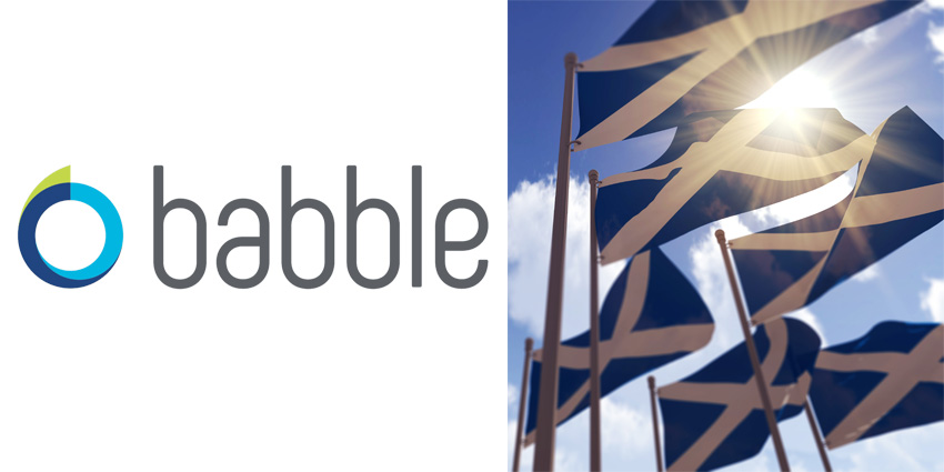 Babble logo alongside raft of scottish flags blowing in the wind